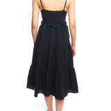 Tiered midi dress with a deep v-neck, adjustable spaghetti straps, ruffled under bodice and smocked back in black