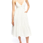 Tiered midi dress with a deep v-neck, adjustable spaghetti straps, ruffled under bodice and smocked back in ivory