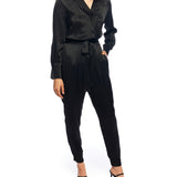 Faux silk jumpsuit with a cross over front, tapered leg, long sleeves, elasticized, tie waist and pockets in black