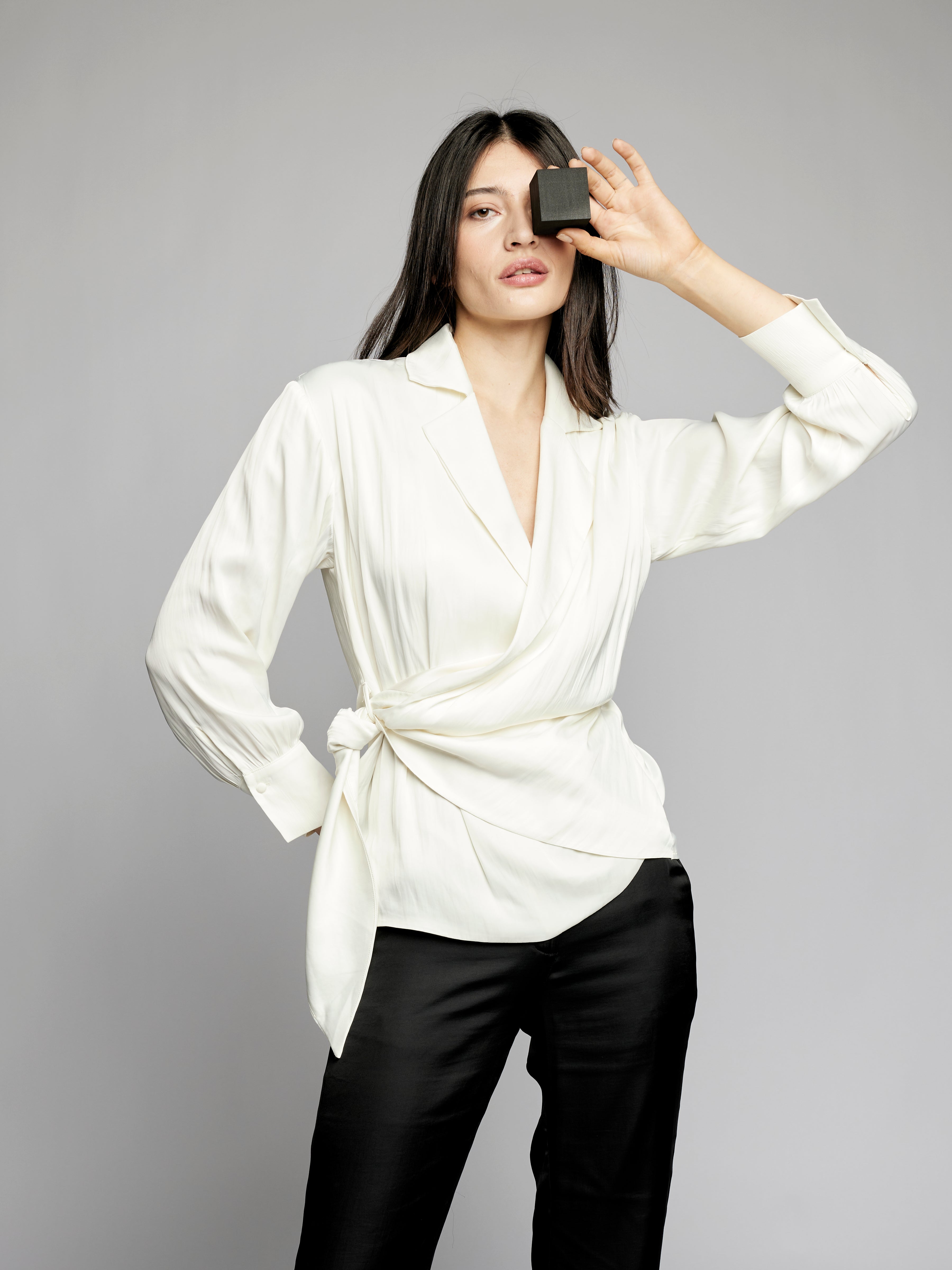 collared, side tie blouse featuring long sleeves with button cuffs in ivory