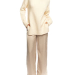vegan knit, turtleneck sweater featuring long sleeves, a relaxed fit, small side slits and a drop shoulder seam in creme