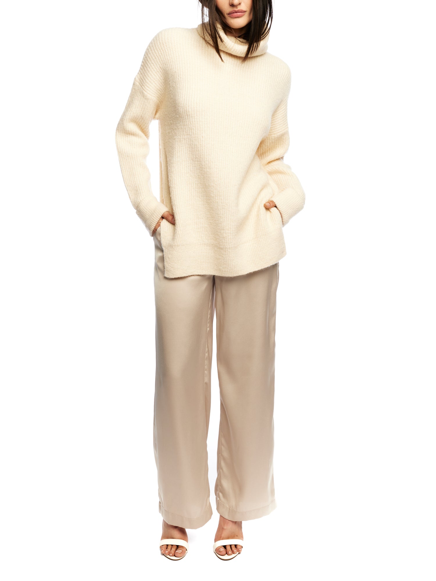 vegan knit, turtleneck sweater featuring long sleeves, a relaxed fit, small side slits and a drop shoulder seam in creme