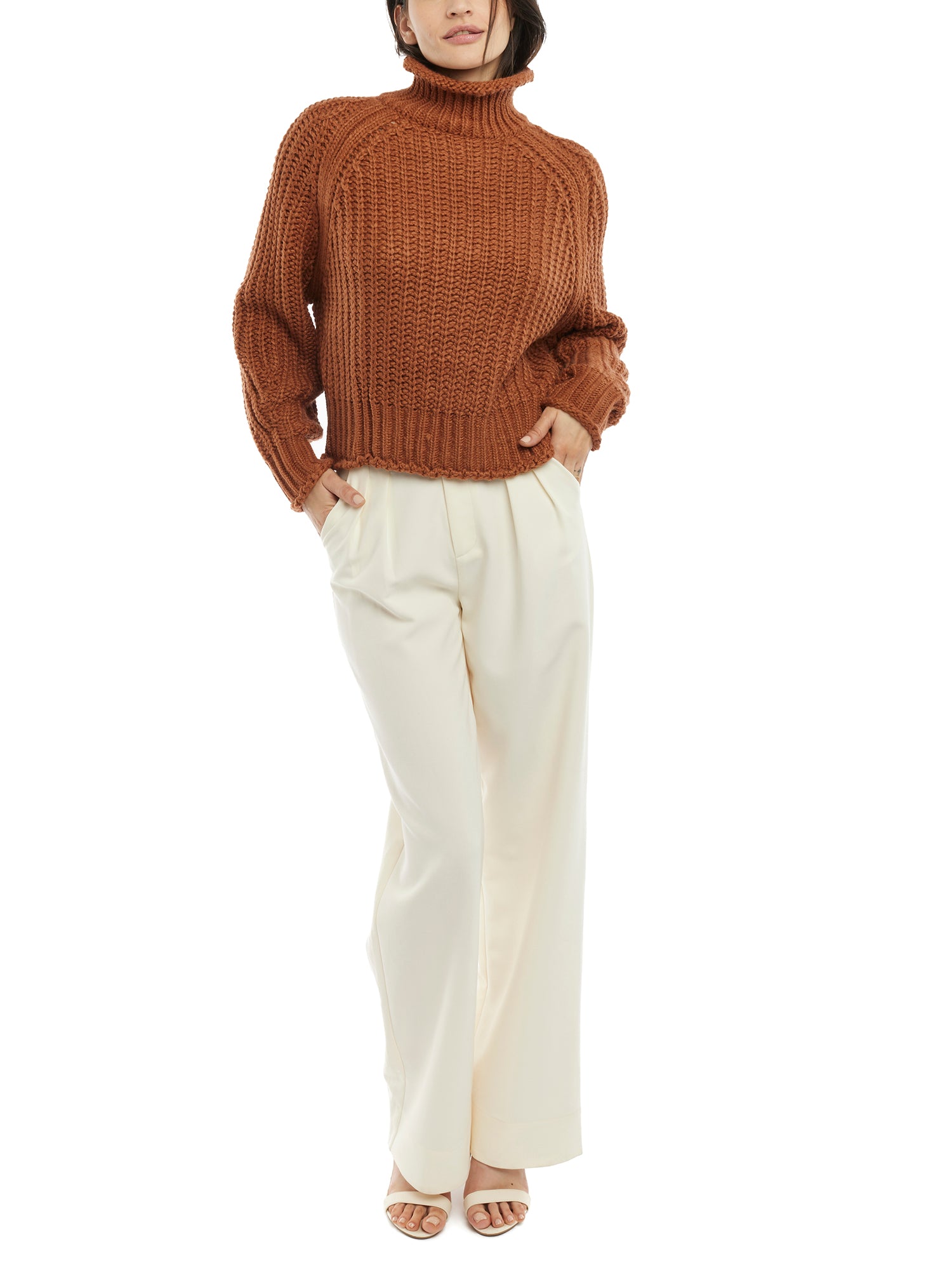 ribbed, chunky knit turtleneck sweater featuring slight balloon sleeves and a funnel neck in rust