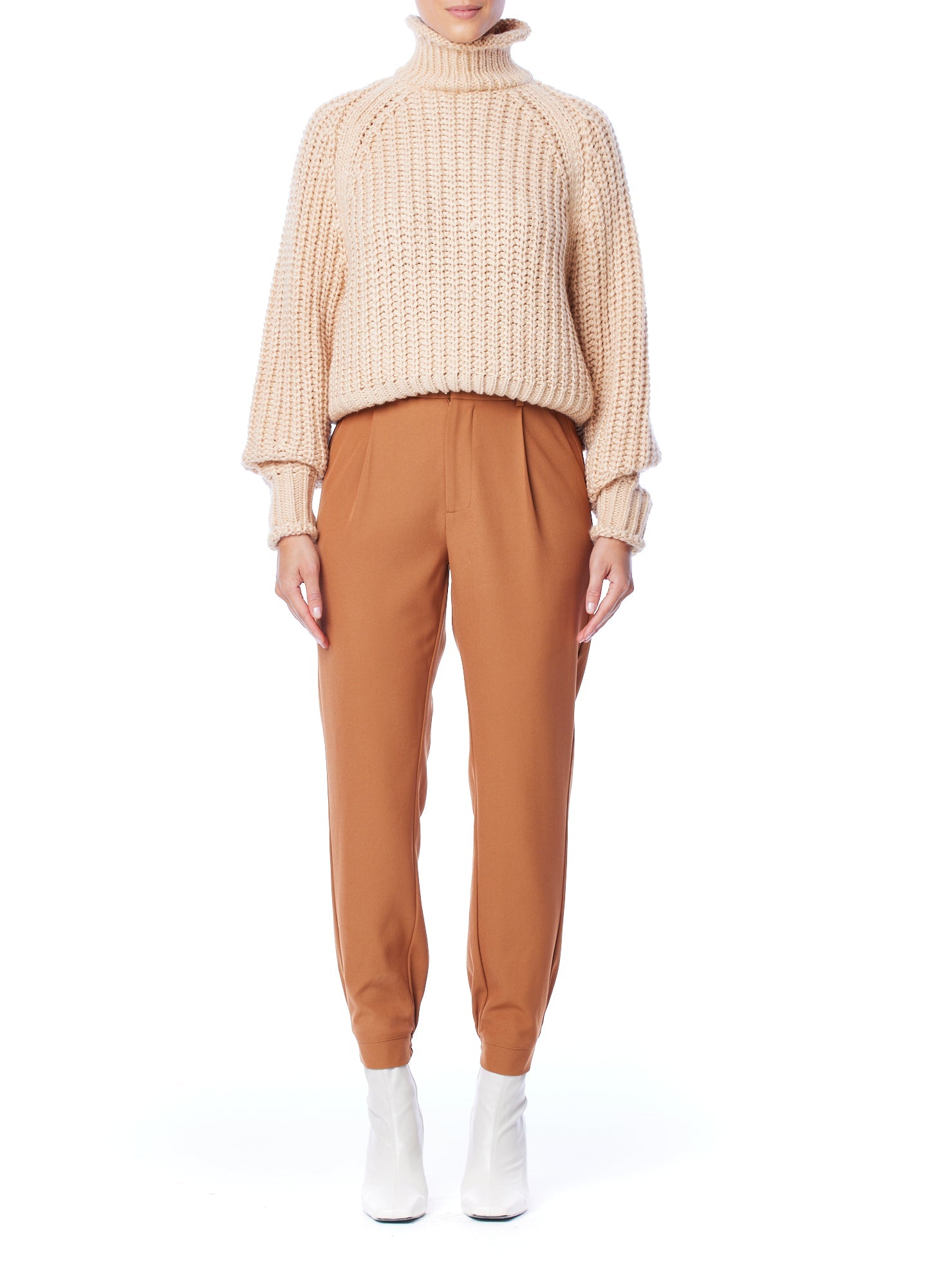 ribbed, chunky knit turtleneck sweater featuring slight balloon sleeves and a funnel neck in blush