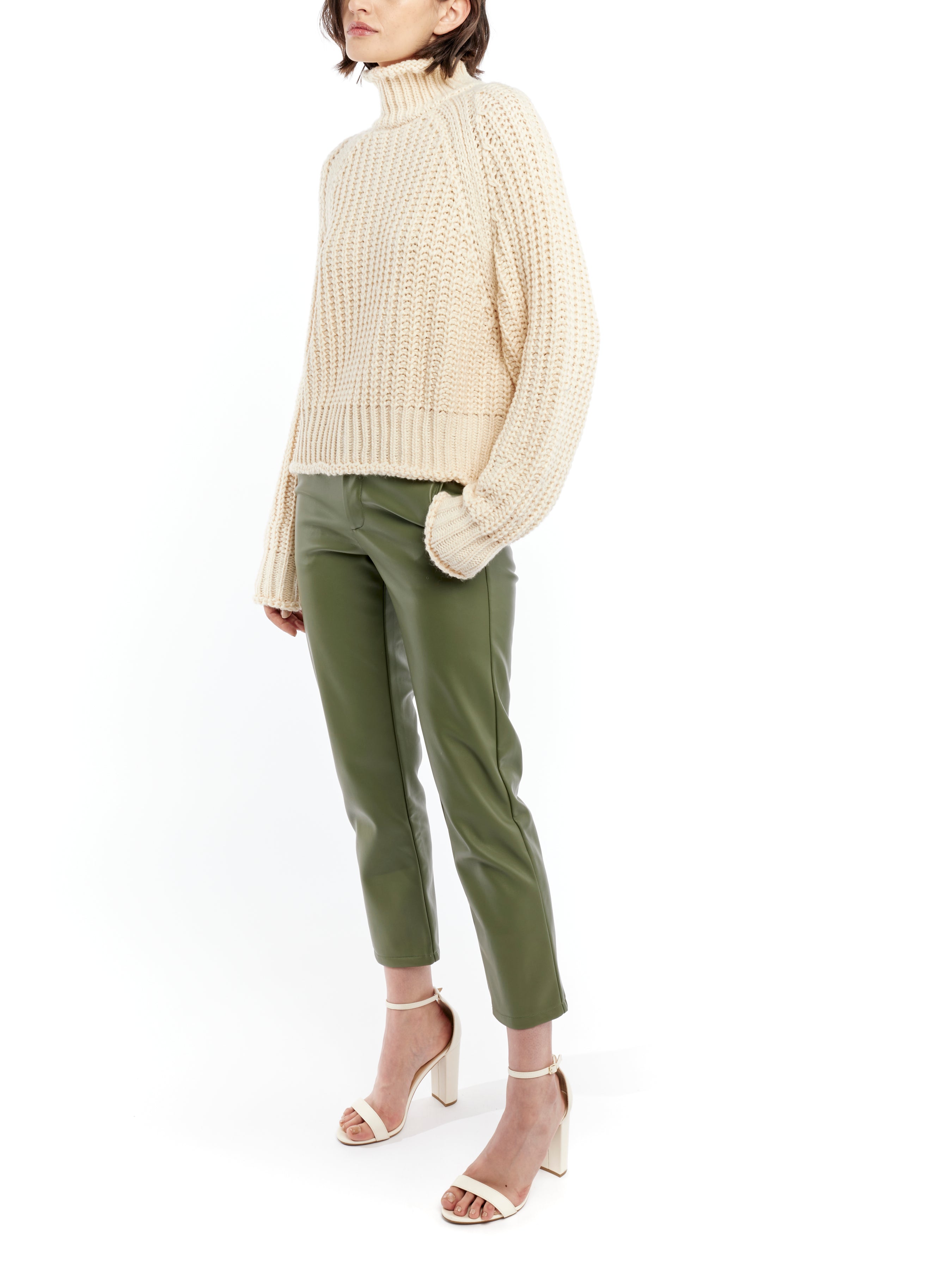 ribbed, chunky knit turtleneck sweater featuring slight balloon sleeves and a funnel neck in creme