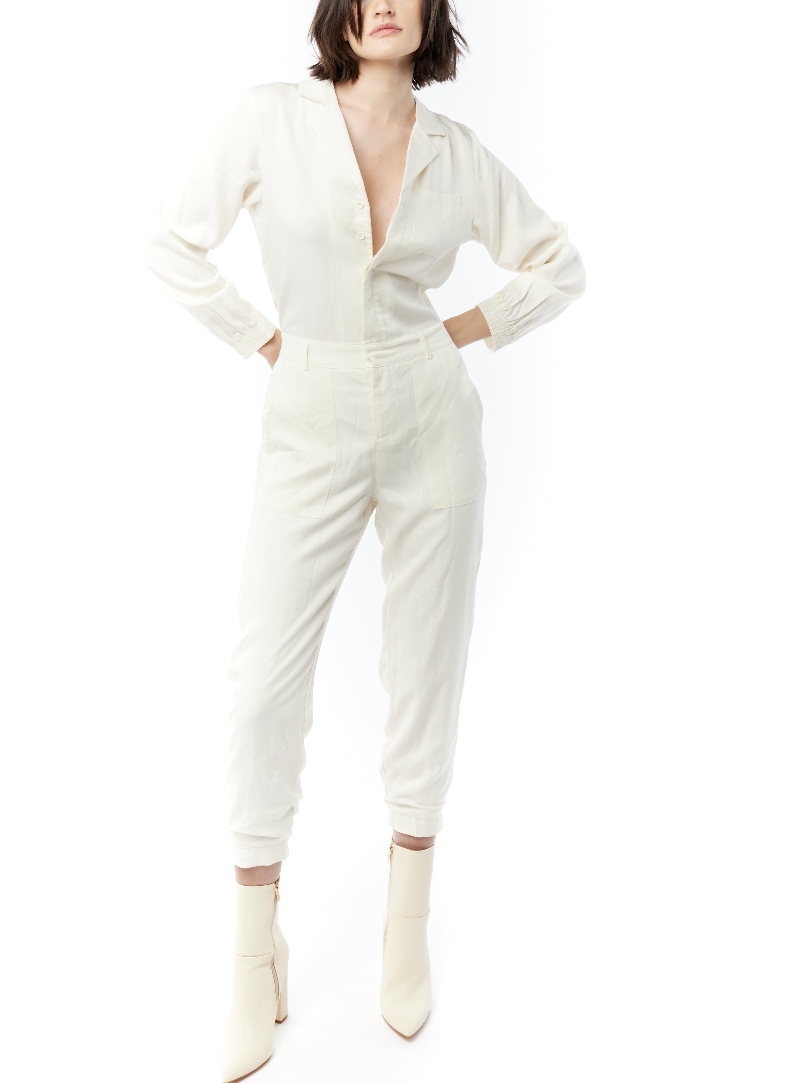 jumpsuit featuring a collared, button-front, long, cuffed sleeves, elasticized waist and bottom cuffs in ivory