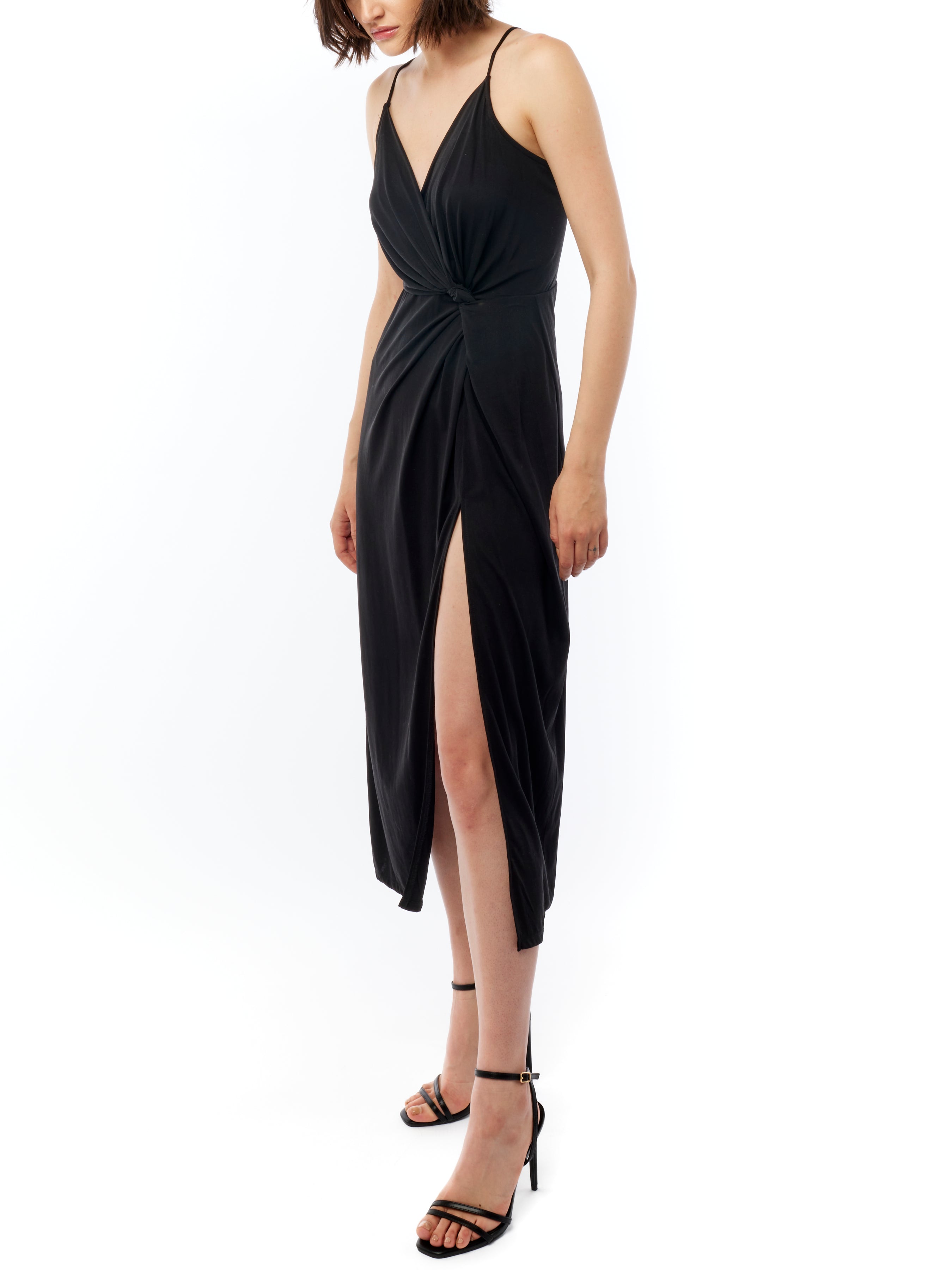 midi dress with a surplice top, gathered twist front, adjustable spaghetti straps and side slit in black