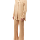 button up satin top featuring long sleeves, elegant collar, buttoned cuffs and a relaxed fit in honey