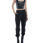 pleated pant with a tapered leg, elasticized cuffs, zip and button closure and side pockets in black