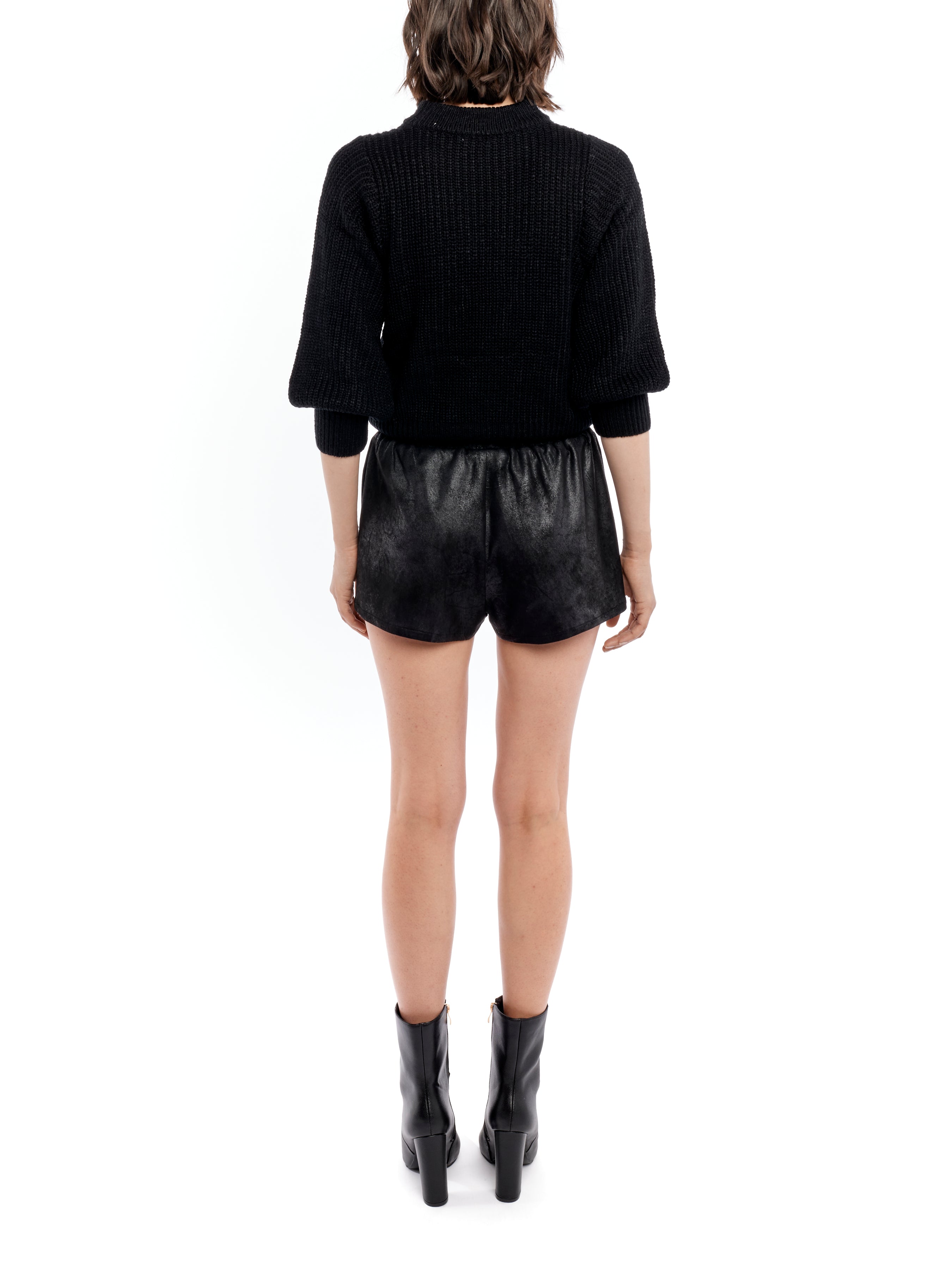 Black mid-rise shorts featuring an elasticized waist and easy, relaxed fit.