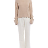 turtleneck sweater with a drop shoulder seam, large rolled cuffs, small side hem slits and a relaxed fit in oatmeal