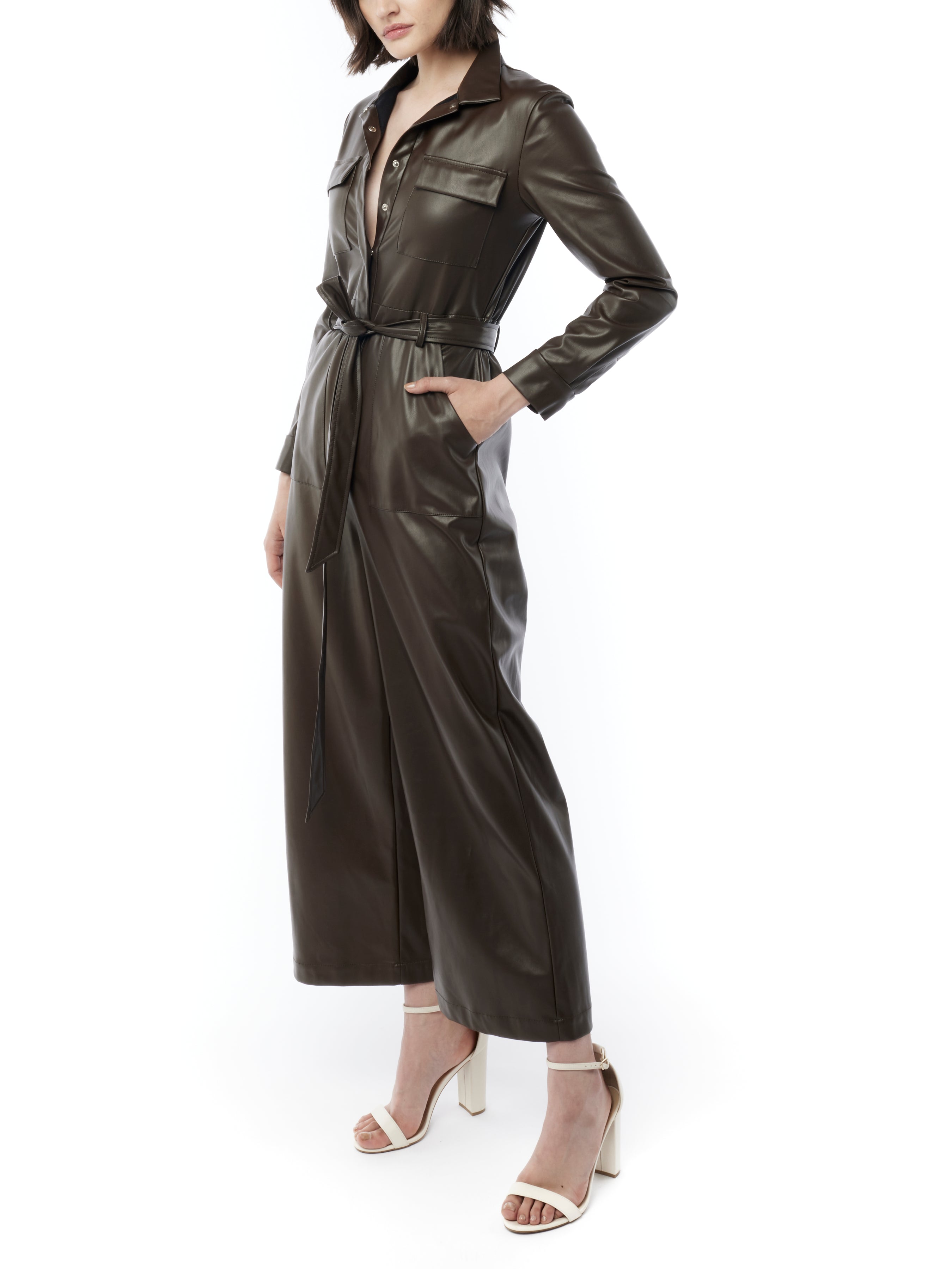 faux leather jumpsuit with long sleeves, wide legs, snap front, pockets and waist tie and elastic waist in maple