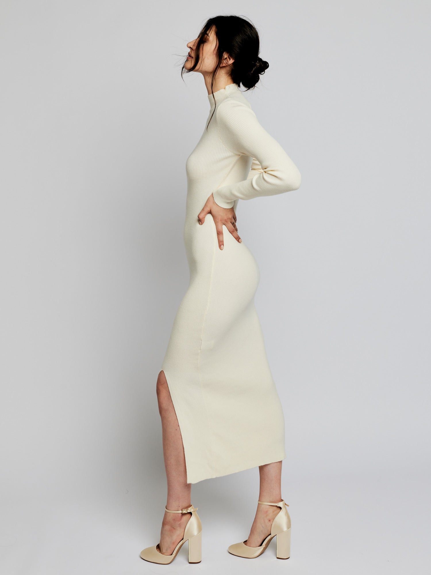 long sleeve, midi dress with a mock turtleneck, ribbed detailing, side slit and back cut out in ivory