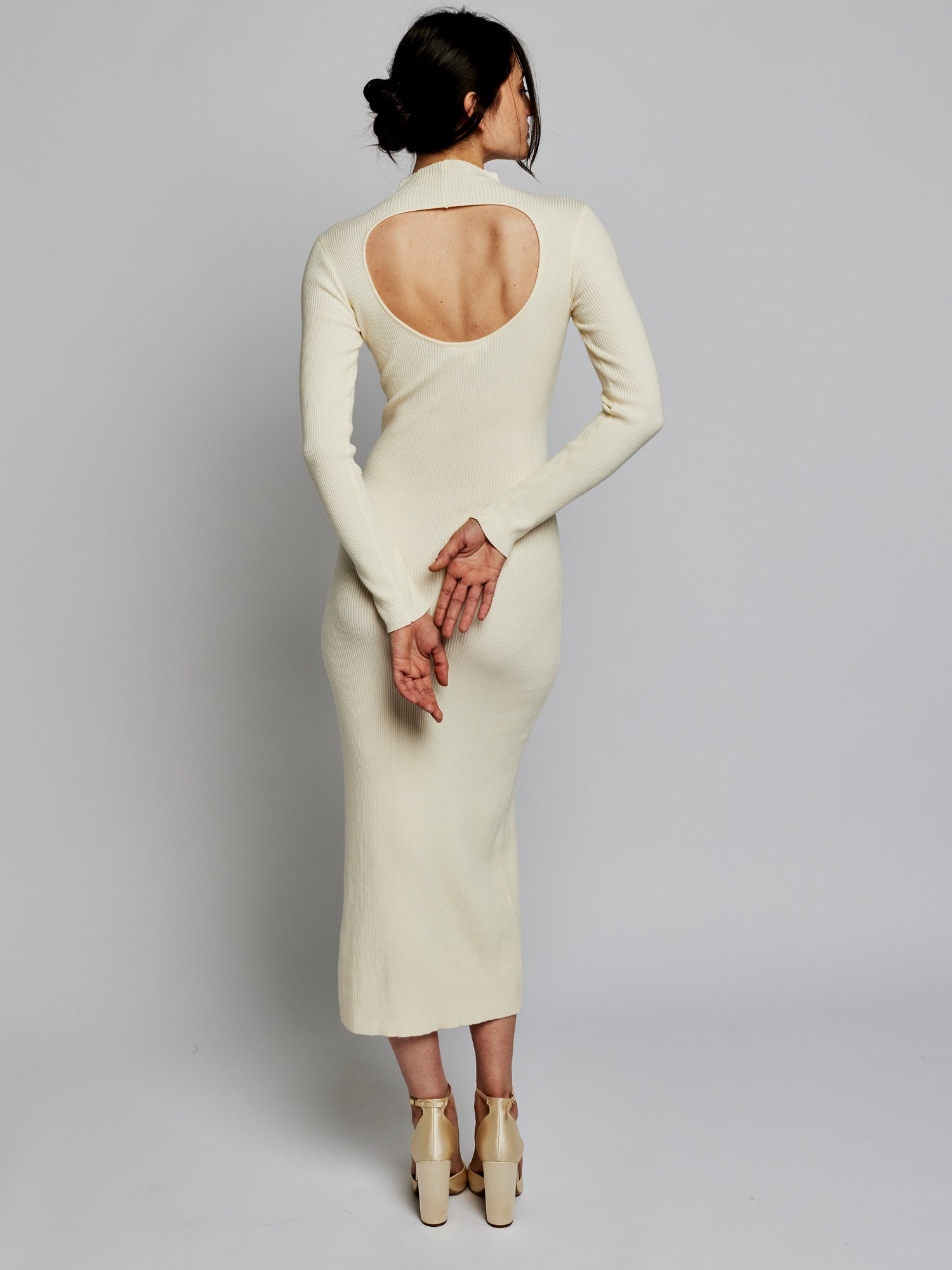 long sleeve, midi dress with a mock turtleneck, ribbed detailing, side slit and back cut out in ivory