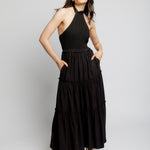 tiered maxi dress with mock neck, tie back halter, smocked bodice and back and ruffled detailing along the tiers in black