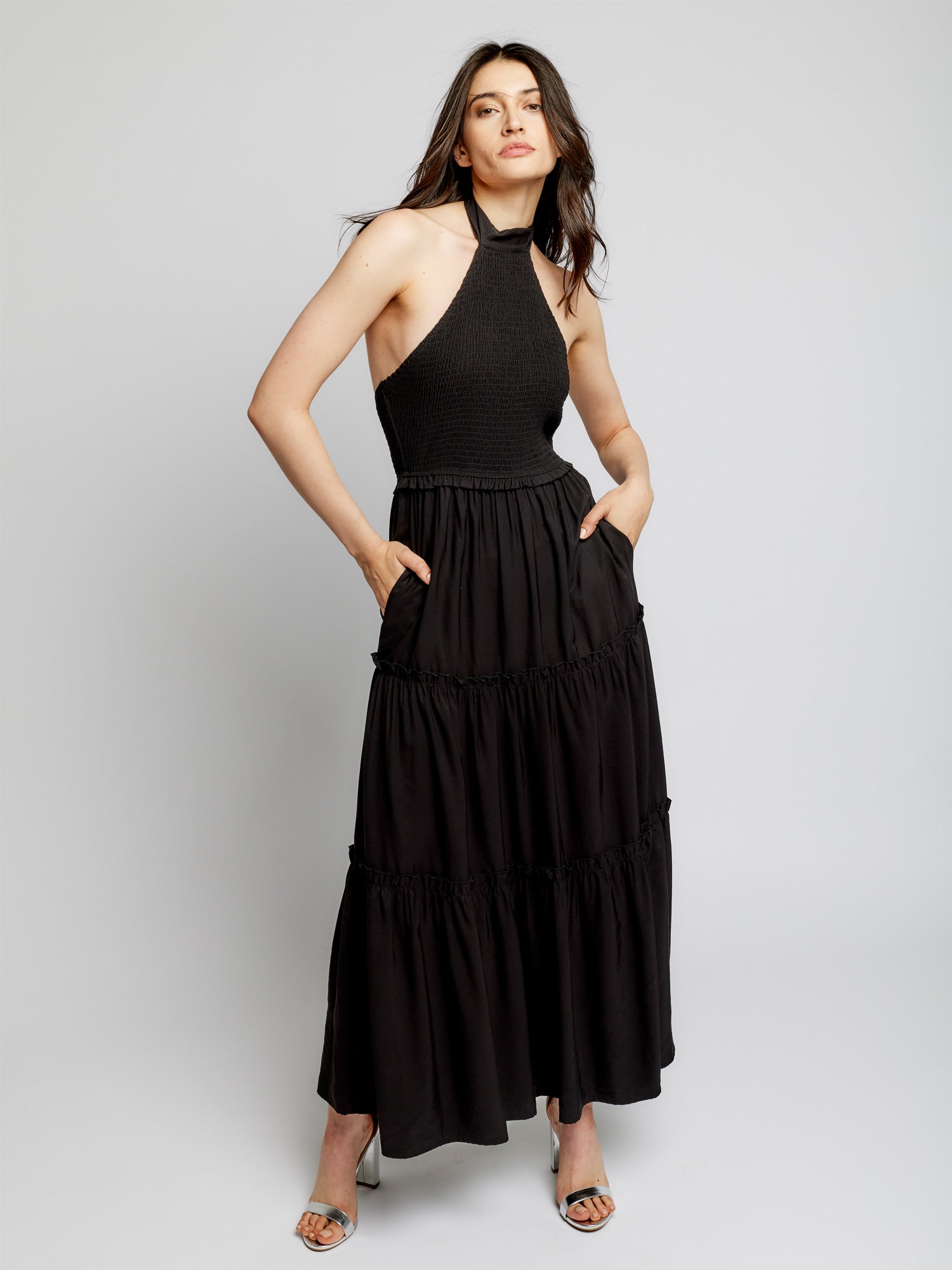 tiered maxi dress with mock neck, tie back halter, smocked bodice and back and ruffled detailing along the tiers in black