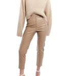 cropped faux leather pant with a mid rise, zipper and button closure and side and back pockets in taupe