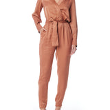 Faux silk jumpsuit with a cross over front, tapered leg, long sleeves, elasticized, tie waist and pockets in rust