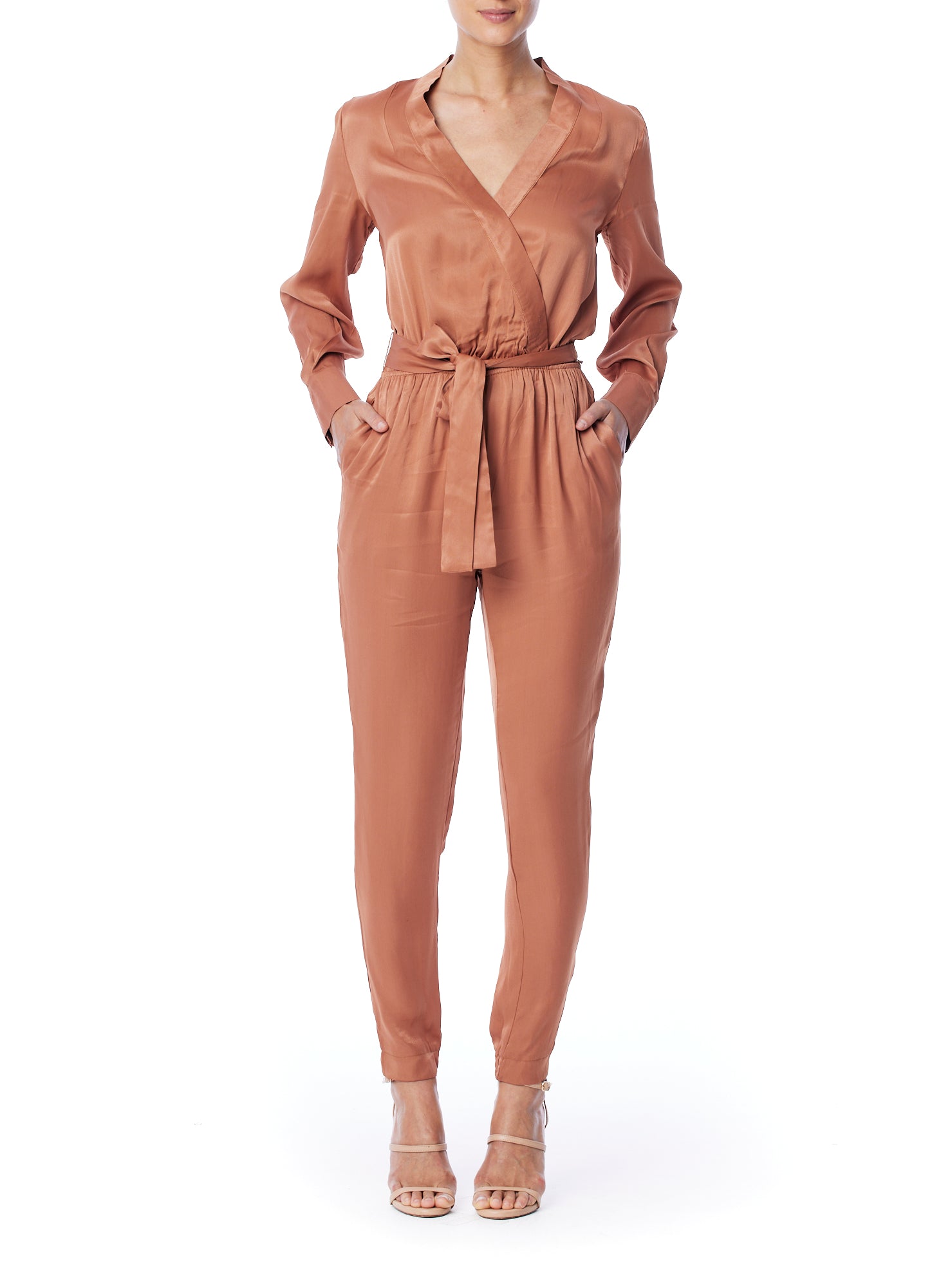 vegan silk jumpsuit with a cross over front, tapered leg, long sleeves, tie waist & side pockets