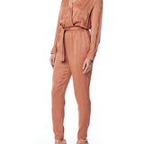 vegan silk jumpsuit with a cross over front, tapered leg, long sleeves, tie waist & side pockets