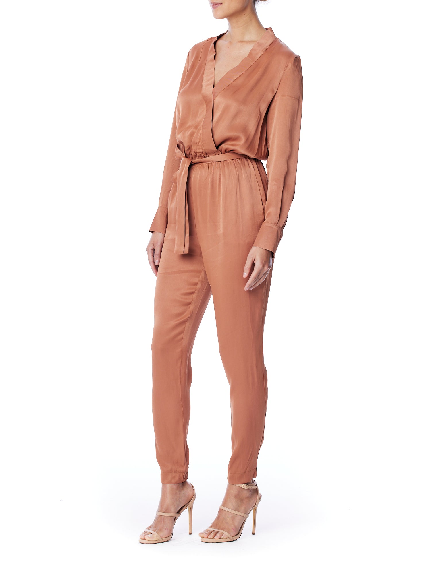 vegan silk jumpsuit with a cross over front, tapered leg, long sleeves, tie waist & side pockets